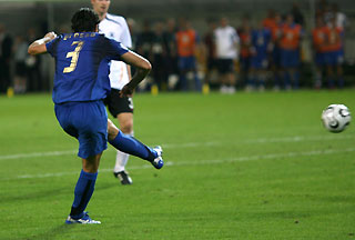 Italy's Fabio Grosso (L) scores his team's first goal against Germany during their World Cup 2006 semi-final soccer match in Dortmund July 4, 2006. 