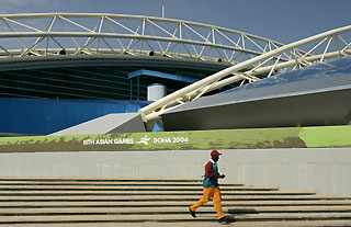 An official walks down the stairs outside 'Aspire', a sports complex for the 15th Asian Games, in Doha November 27, 2006. 