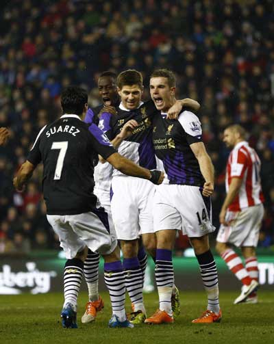 Suarez scores twice as Liverpool beats Stoke 5-3