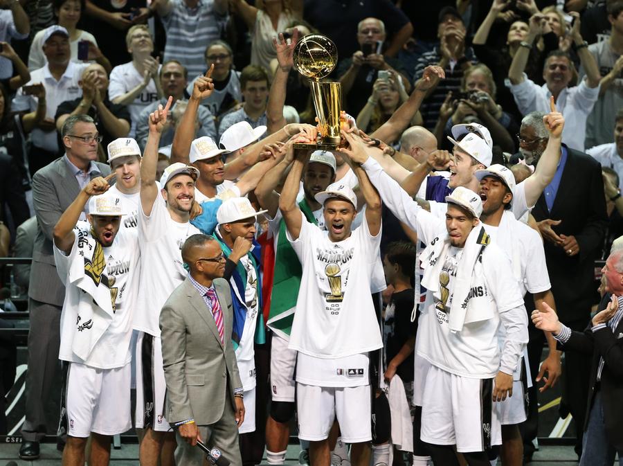 The San Antonio Spurs celebrate with the Larry O'Brien trophy after  defeating the Miami Heat following game 5 of the NBA Finals at the AT&T  Center at the AT&T Center in San