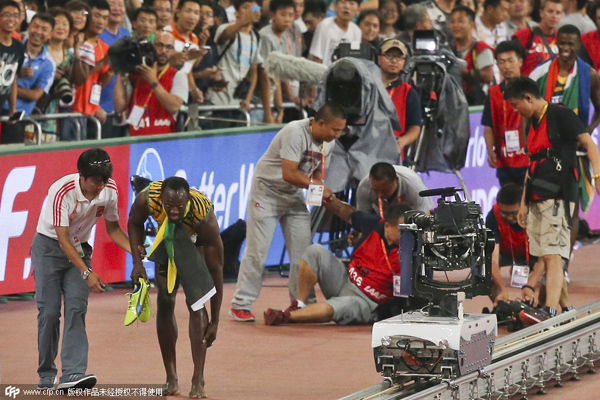 Bolt 'somersaults' after cameraman takes him down