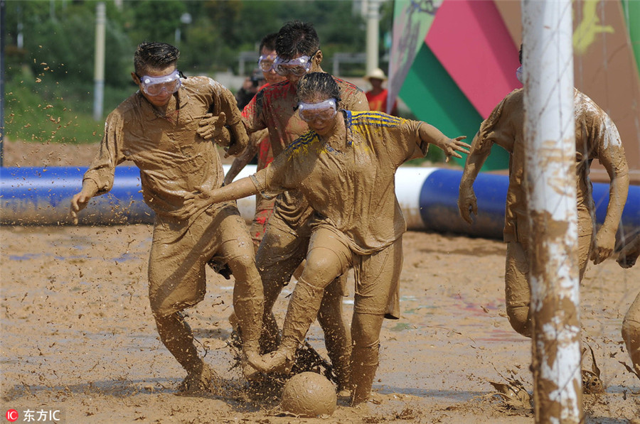 Swamp soccer: Players battle for ball in Nanjing