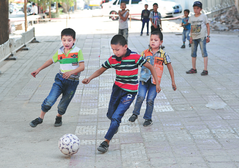 Xinjiang kids look to score on their own field of dreams