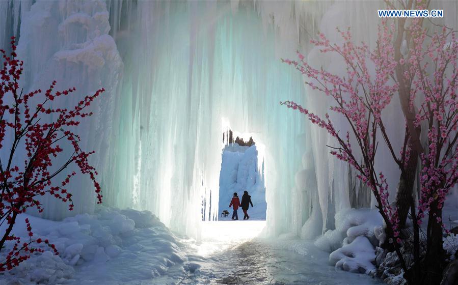 People visit frozen waterfall in N China
