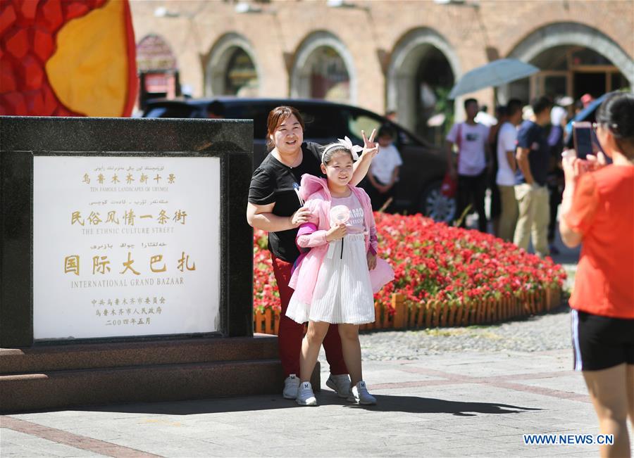 Tourists visit Int'l Bazar at Urumqi in NW China's Xinjiang