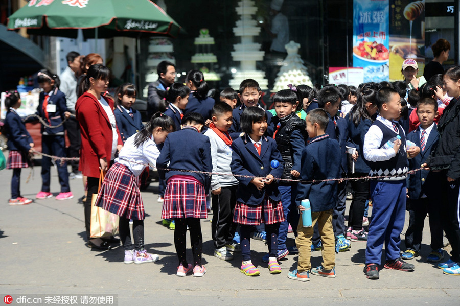 Students walk in rope circle to cross street