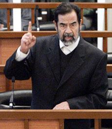 Former Iraqi president Saddam Hussein argues during his trial in Baghdad's Green Zone April 5, 2006. Hussein lashed out at Iraq's Interior Ministry just after his trial resumed on Wednesday, accusing it of killing thousands of Iraqis.