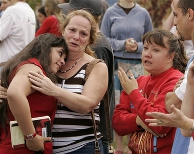 Platte Canyon High School student were reunited with parents and family after being evacuated from the school near Bailey, Colo., on Wednesday, Sept. 27, 2006. A middle-aged gunman walked into the high school of this mountain town Wednesday, shot and critically wounded a student and then killed himself after SWAT team members entered the building, authorities said. (AP 