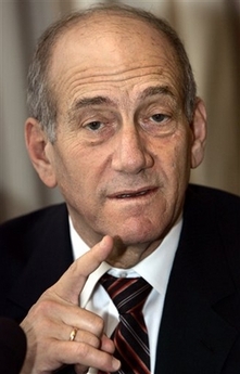 Israeli Prime Minister Ehud Olmert gestures during a meeting with the families of soldiers serving in the Israeli armed forces, Moscow, Thursday, Oct. 19, 2006. Although ties between Russia and Israel have warmed dramatically since the Soviet Union collapsed, the two countries are in deep disagreement over how to confront the Iranian nuclear threat. After meeting with Russian President Vladimir Putin on Wednesday Olmert said Iran cannot be prevented from gaining nuclear arms if it is not afraid of retribution. (AP 