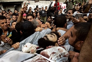 Palestinian mourners carry the body of Mohammed Shimbari during a funeral of five members from the Shimbari family in the town of Beit Hanoun, northern Gaza Strip, Tuesday Oct. 24, 2006. Israeli troops shot and killed Monday seven Palestinians, including three brothers and two of their cousins from the Shimbari family, in the northern Gaza Strip, in one of the deadliest days of fighting in Israel's 4-month-old offensive in the coastal area. (AP