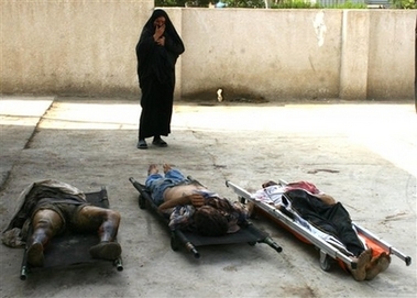 A woman reacts as she looks at the body of her son-in-law, right, in a hospital yard in Baqouba, 60 kilometers (35 miles) northeast of Baghdad, Thursday Nov. 2, 2006. A total of eleven bodies were discovered by police in Baqouba Thursday. At least 49 people were killed or found dead around Iraq on Thursday, including seven people killed when a motorcycle rigged with explosives blew up in a crowded market in Baghdad's Shiite Sadr City district. At least 45 people were injured, many of them seriously, police said. (AP 