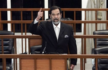 Former Iraqi President Saddam Hussein yells at the court as the verdict is delivered during his trial held under tight security in Baghdad's heavily fortified Green Zone, Sunday Nov. 5, 2006. Iraq's High Tribunal on Sunday found Saddam Hussein guilty of crimes against humanity and sentence him to die by hanging.
