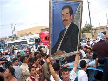 A man holds up a framed image of deposed Iraqi leader Saddam Hussein as they protest his death sentence for crimes against humanity, in Fallujah, 65 kilometers (40 miles) west of Baghdad, Iraq, Monday Nov. 6, 2006. About 150 people marched through Fallujah, a former stronghold of the Sunni insurgency 65 kilometers (40 miles) west of Baghdad, denouncing the verdict and shouting: 'We sacrifice our souls for you Saddam.' (AP
