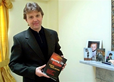 Alexander Litvinenko, former KGB spy and author of the book 'Blowing Up Russia: Terror From Within' photographed at his home in London in this Friday, May 10, 2002 file photo. Police said Sunday, Nov. 19, 2006 they were investigating the suspected poisoning in London of the former Russian spy and outspoken Kremlin critic who had accused his former colleagues of involvement in terrorism and assassinations. Scotland Yard said it began an investigation on Friday. Col. Alexander Litvinenko, 43, was under armed guard in University College Hospital in London. (AP Photo/Alistair Fuller) (AP