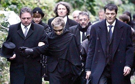 Marina Litvinenko, center, attends the burial of her husband, Alexander Litvinenko, at Highgate Cemetery in London on Thursday. He died Nov. 23, after being poisoned.