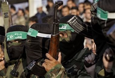 Palestinan masked Hamas militants march during the funeral of Bassam al-Fara, a local Hamas leader, in Khan Younis, in the southern Gaza Strip, Wednesday, Dec. 13, 2006. 