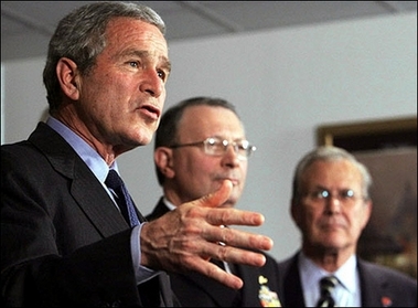 US President George W. Bush (L) speaks as Vice Chairman of the Joint Chiefs of Staff Ed Giambastiani (C) and outgoing Defense Secretary Donald Rumsfeld look on following a meeting with senior Department of Defense officials at the Pentagon in Washington, DC. Bush vowed not to be rushed into unveiling his new Iraq strategy overhaul, as he defended his decision to delay an announcement until early 2007.(AFP