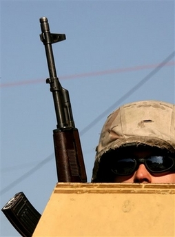 An Iraqi army soldier oversees traffic at a vehicle checkpoint in Baghdad, Iraq, Thursday, Feb. 8, 2007. U.S. officials confirmed the new security operation which will involve about 90,000 Iraqi and American troops and is seen by many as a last chance to curb Iraq's sectarian war was under way after a delayed start. (AP