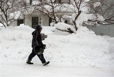 Letter carrier Don Feltt makes his appointed rounds delivering the mail in Oswego, N.Y., Saturday, Feb. 10, 2007. (AP 