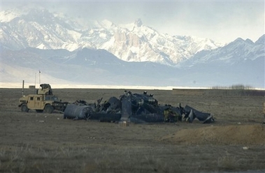A U.S. military humvee guards the scene of a U.S. helicopter crash in the Shahjoi district of Zabul province in southeastern Afghanistan on Sunday Feb. 18, 2007. 