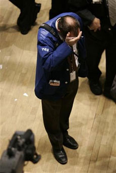 A trader on the floor of the New York Stock Exchange holds his head in his hand during the closing minutes of the trading session in New York, February 27, 2007. U.S. stocks plummeted on Tuesday, sending the benchmark S and P 500 index to its biggest one-day slide in more than 3-1/2 years as a sell-off in China's equity market fanned worries that stock valuations there are too high and some data indicated U.S. economic growth may slow. (Mike Segar/Reuters) 