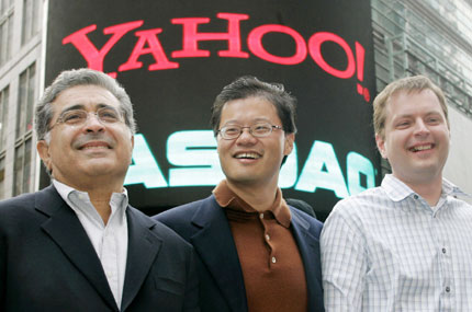Yahoo! co-founders Jerry Yang (C) and David Filo (R) pose with chief executive Terry Semel in front of the NASDAQ MarketSite in Times Square in New York after ringing the opening bell at NASDAQ in this March 2, 2005 file photo. Following investor pressure for a management CEO Semel is stepping aside and will be replaced as CEO by Yang, Yahoo said on June 18, 2007. 