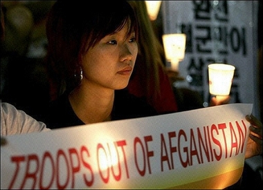 A South Korean woman attends a candlelight vigil in Seoul, demanding the withdrawal of South Korean troops from Afghanistan and the safe return of their kidnapped compatriots. 