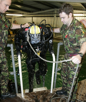 Britain's Prince Harry (C) is helped out the water after carrying out some underwater engineering during his visit to the Royal Navy's fleet diving squadron at Horsea Island in Portsmouth, southern England, Oct. 31, 2007. It was Prince Harry's first official visit since becoming Commodore-in-Chief of small ships and diving.