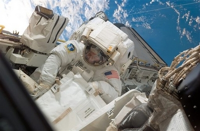 In this image provided by NASA astronaut Robert L. Behnken, participates in the mission's fourth spacewalk Thursday March 20, 2008 as construction and maintenance continue on the International Space Station. During the 6-hour, 24-minute spacewalk, Behnken and astronaut Mike Foreman (out of frame), replaced a failed Remote Power Control Module -- essentially a circuit breaker -- on the station's truss. The spacewalkers also tested a repair method for damaged heat resistant tiles on the space shuttle. The sample tiles will be returned to Earth to undergo extensive testing on the ground. [Agencies]