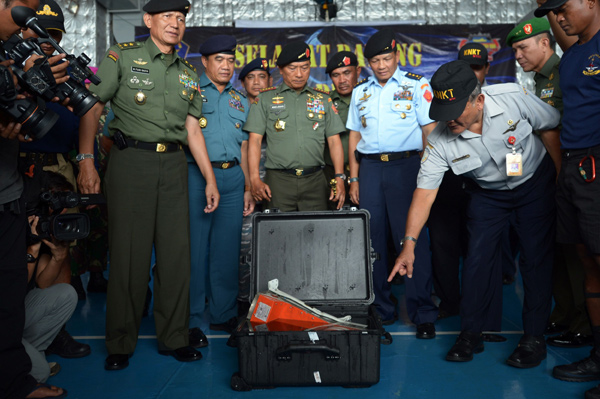 Divers retrieve AirAsia 'black box', explosion theory questioned