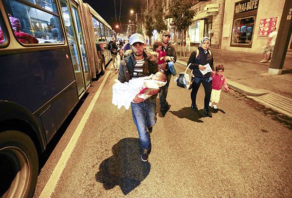 Migrants stream into Austria, swept west by overwhelmed Hungary