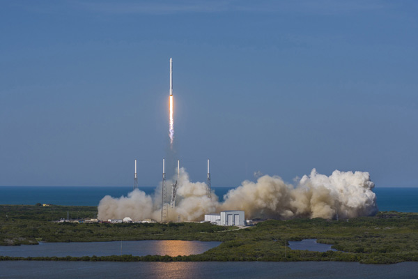 SpaceX rocket blasts off, then lands on ocean platform