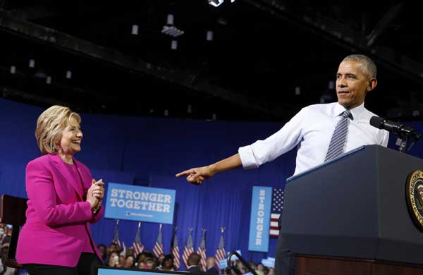 Obama hits campaign trail, says ready to 'pass baton' to Clinton