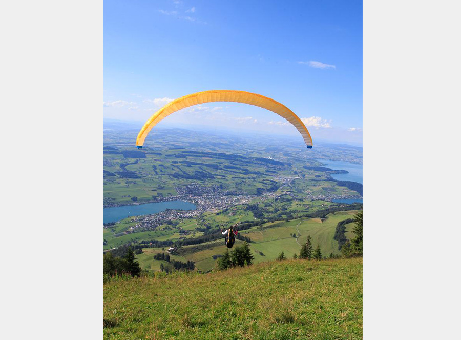 Paragliding fans fly over Rigi mountain in Switzerland