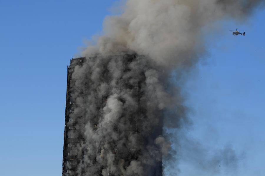 Fire engulfs London tower block, at least 12 dead