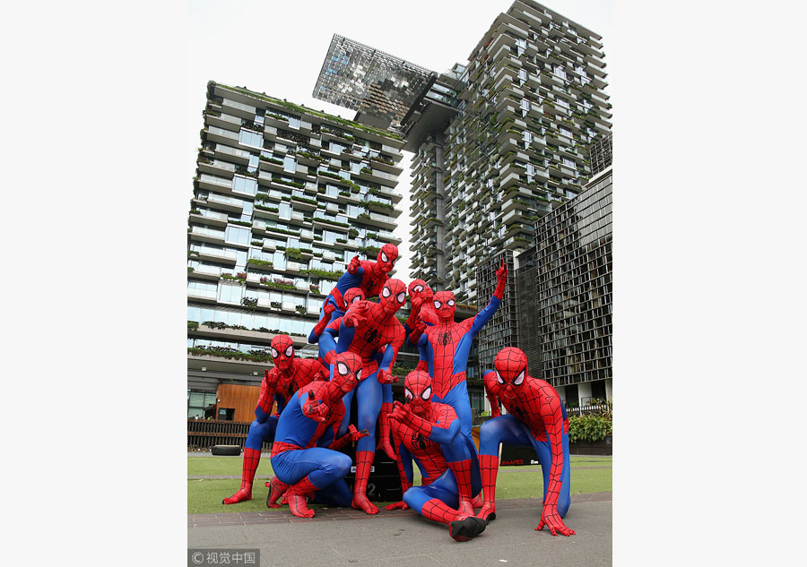 Parkour athletes dressed as spiderman scale Sydney mall