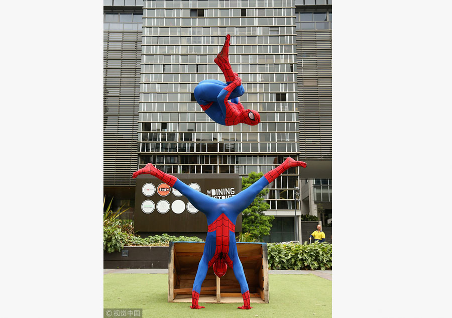 Parkour athletes dressed as spiderman scale Sydney mall
